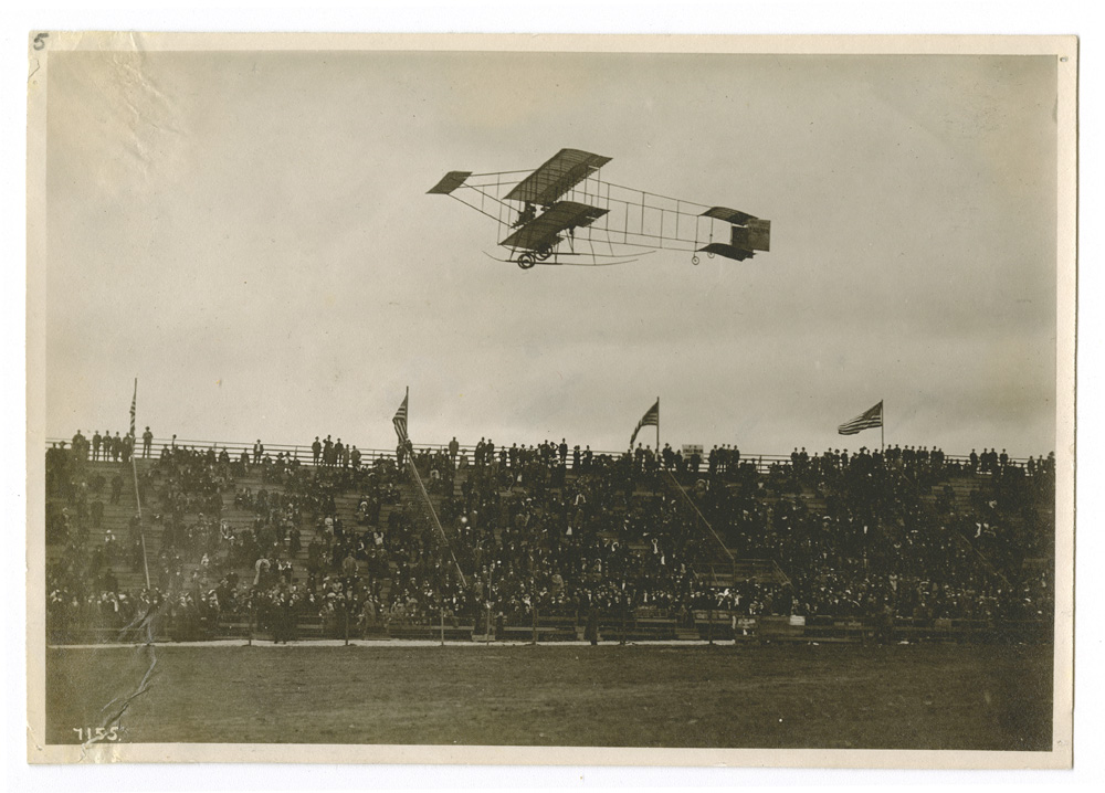 Louis Paulhan Flying His Plane in Front of the Stands, Dominguez Hills Air Meet, 1910