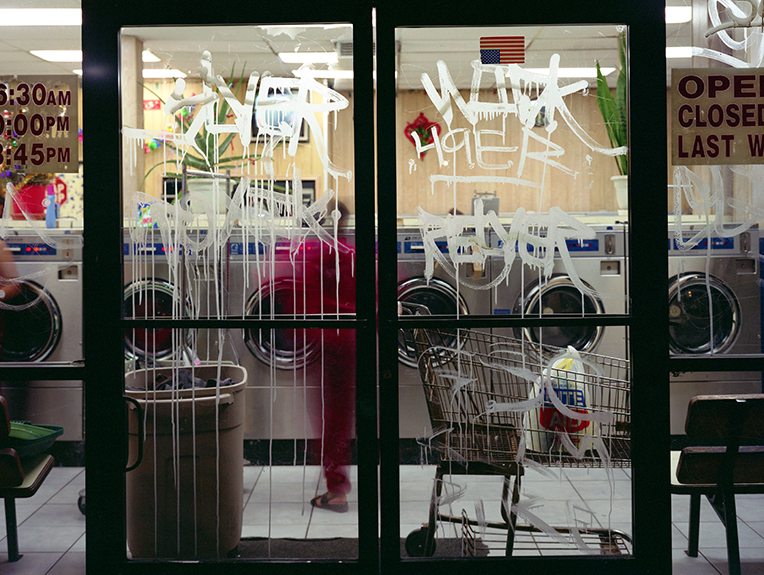 photo of Laundromat door with graffiti