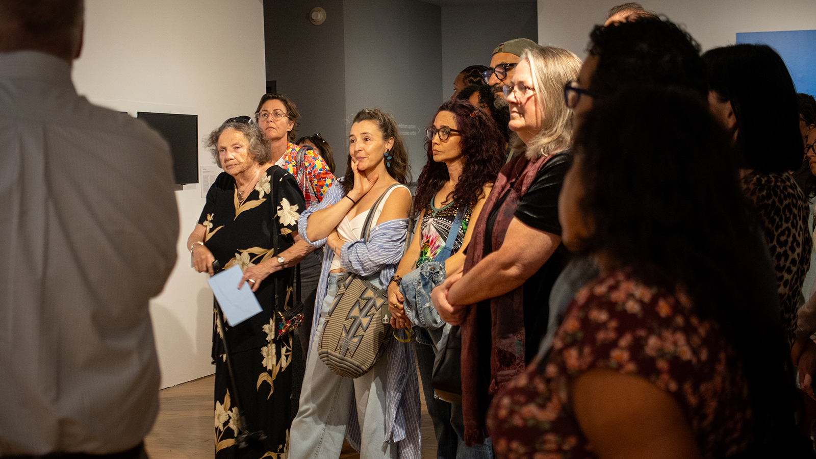 Group of people standing in an art gallery